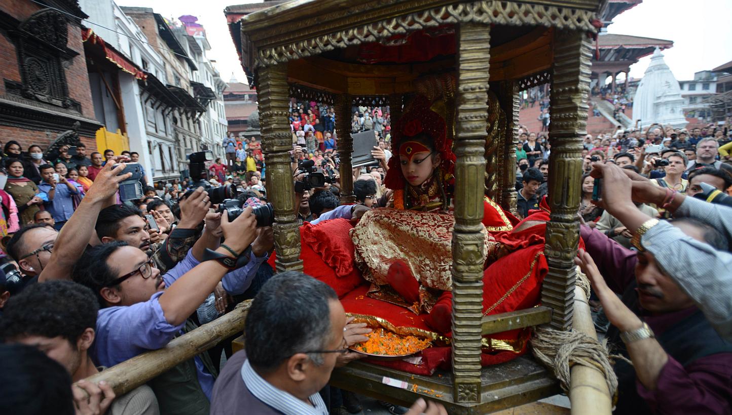 Nepal's Living Goddess the "Kumari Devi" is carried by worshippers during a procession on the third day of the Seto Machindranath chariot festival in Kathmandu on March 29, 2015. --PHOTO: AFP