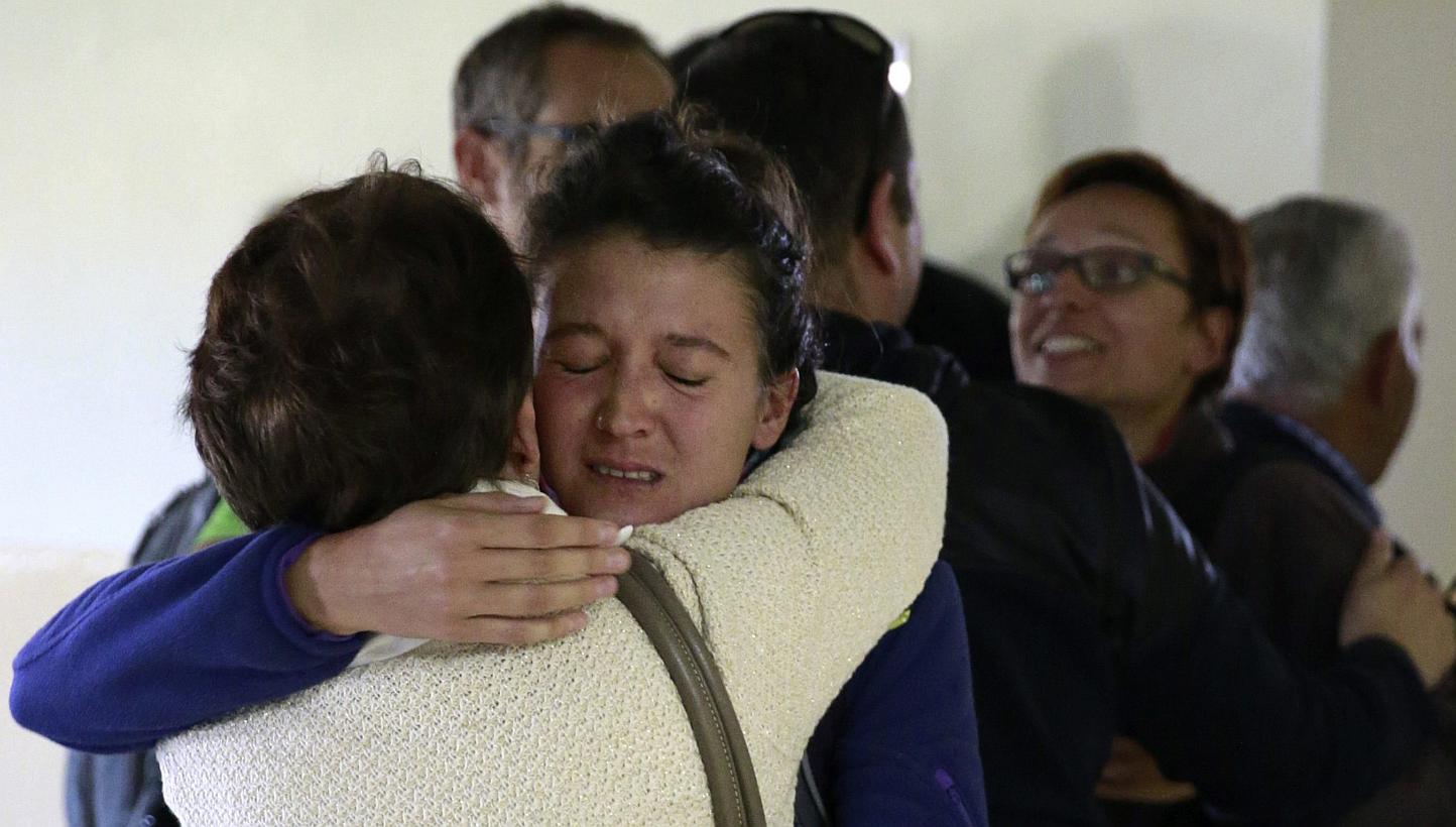 A relative embracing a Spaniard evacuated from Nepal at an air base outside of Madrid on April 28, 2015. 1,000 European Union citizens are still unaccounted for in Nepal, diplomats said, almost a week after a massive earthquake that has claimed more 