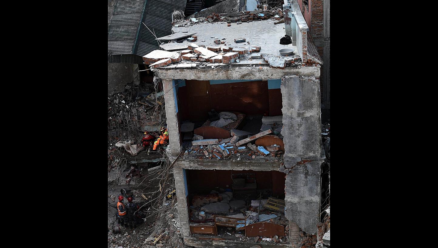 A search and rescue team at a destroyed building in Kathmandu on Thursday. Unstable geological conditions, together with high density and substandard building stock, create a dangerous environment in the city.