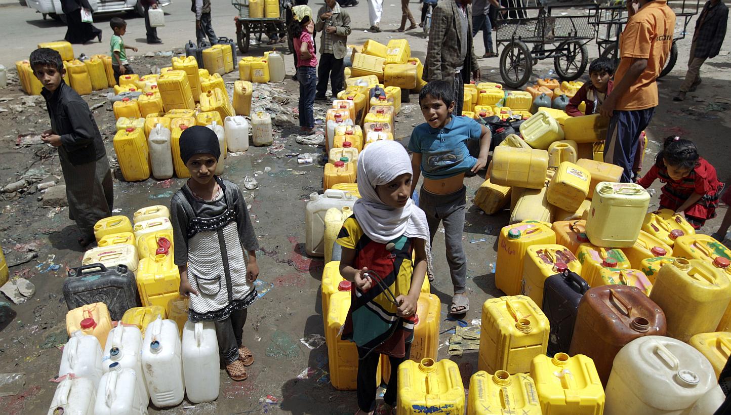 Yemeni children wait to fill their jerrycans with water from a public tap amid an acute shortage of water supply to houses in the capital Sanaa, on April 26, 2015. -- PHOTO: AFP
