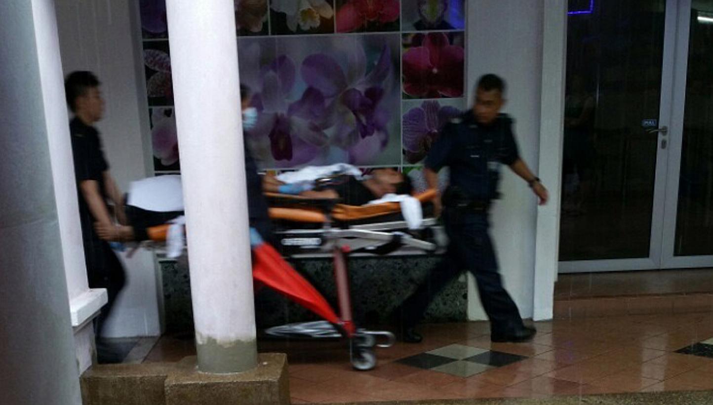 Mr Nasu being taken to an ambulance. -- PHOTO: THE NEW PAPER READER