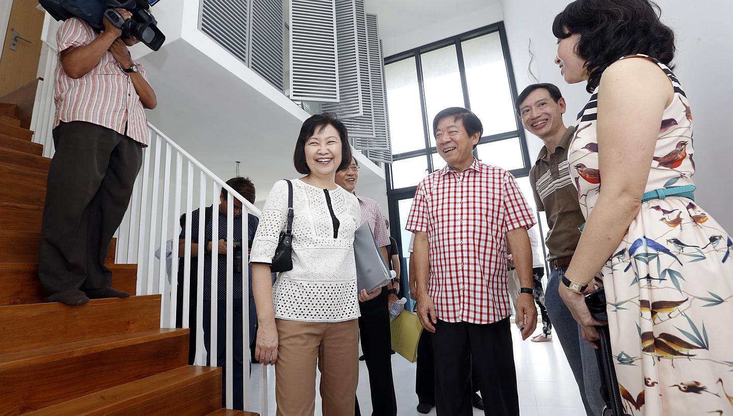 Minister for National Development, Mr Khaw Boon Wan meets new owners of a SkyTerrace@Dawson multi-generational loft unit, Mr Calvin Tang (second from right), a 48-year-old social worker, and wife Amy (right), a 45-year-old key account executive, duri