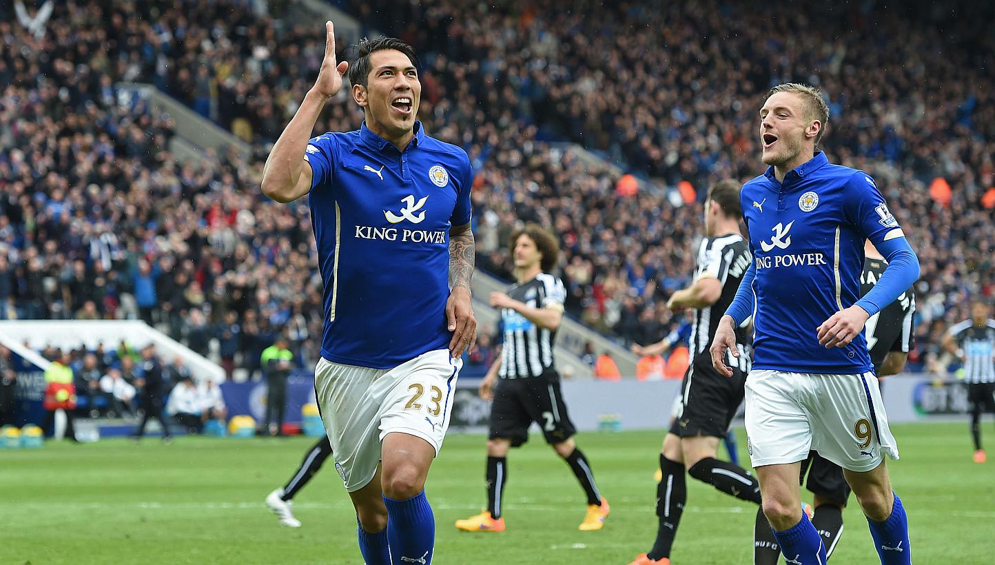 Leonardo Ulloa (left) celebrates scoring the third goal for Leicester from the penalty spot. -- PHOTO: REUTERS