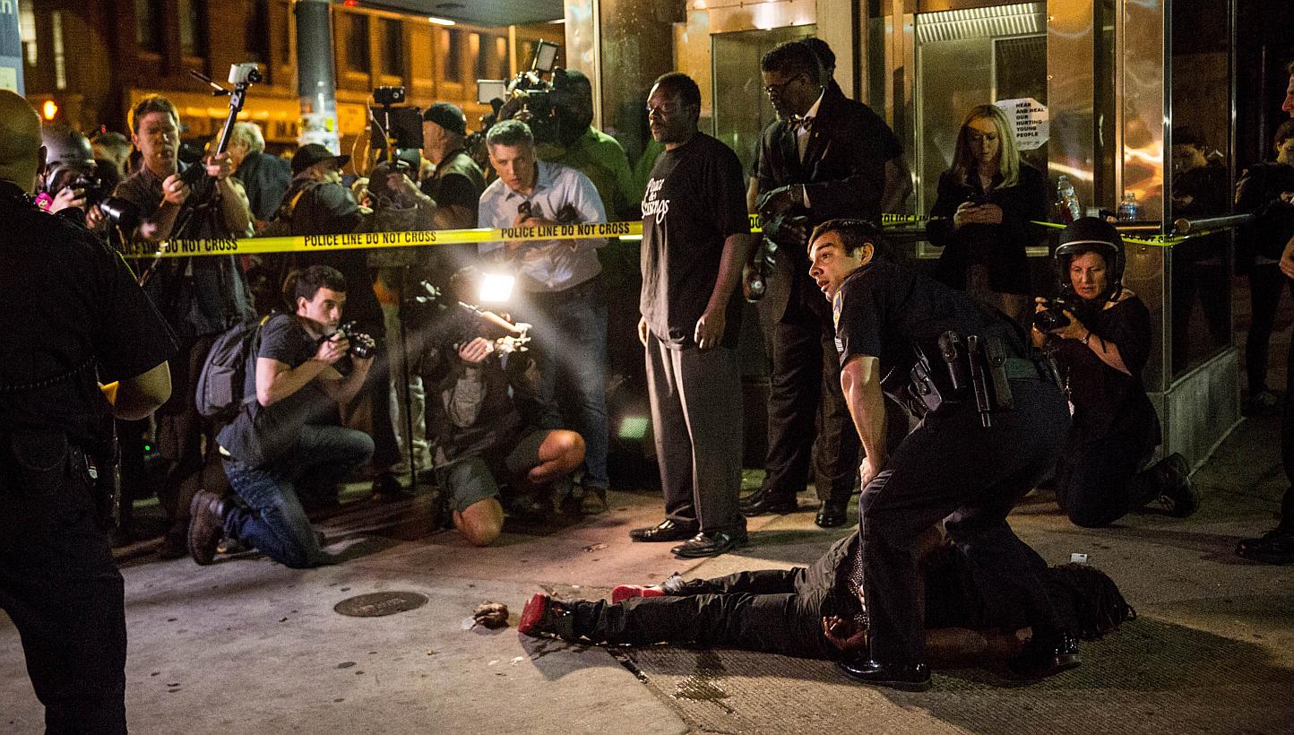 A man is detained after being pepper sprayed in the face by police at the end of a day of protests in the Sandtown neighborhood where Freddie Gray was arrested on May 2, 2015 in Baltimore, Maryland. -- PHOTO: AFP 