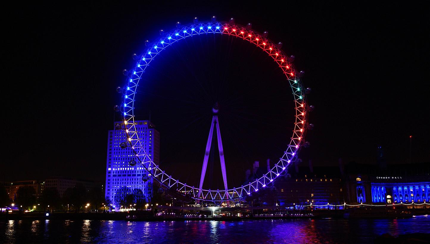 The London Eye overlooking the River Thames as seen on Friday, lit in colours that represent the different political parties vying for support in the British general election. The colours are meant to reflect how many interactions each party chalks u