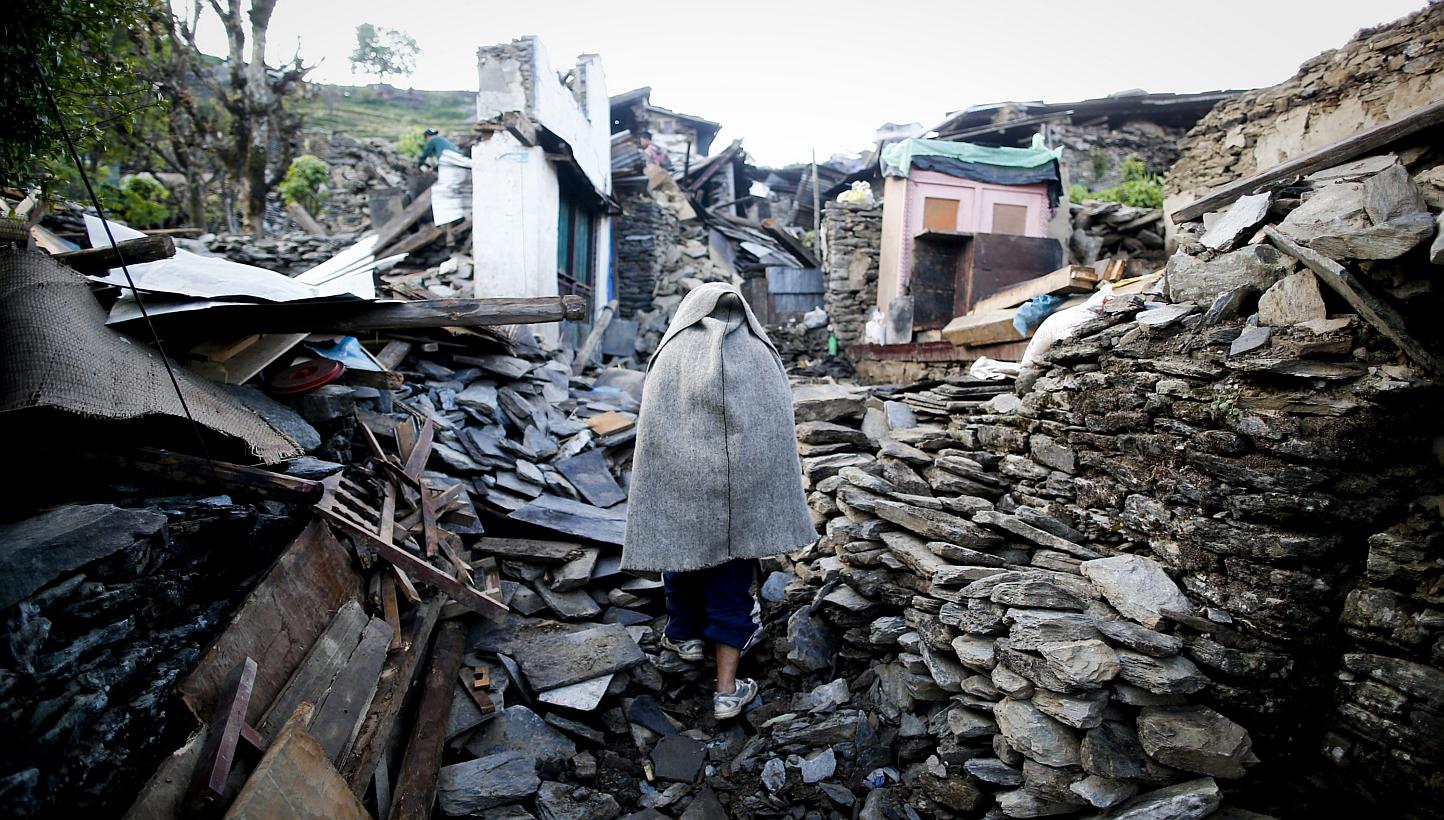 A man walks through what is left from Barpak village, Gorkha district, epicentre of the devastating earthquake that hit the country on April 25, 2015. -- PHOTO: EPA&nbsp;