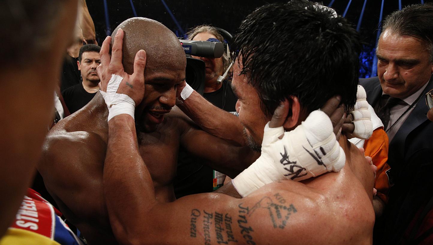 Floyd Mayweather Jr. hugs Manny Pacquiao after defeating Pacquiao in their welterweight unification bout on May 2, 2015 at the MGM Grand Garden Arena in Las Vegas, Nevada.&nbsp;-- PHOTO: AFP