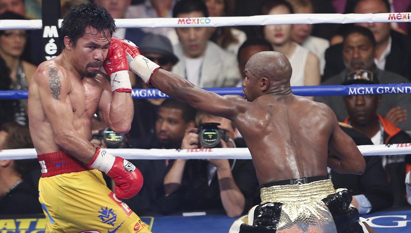 Floyd Mayweather Jr. (right) in action against Manny Pacquiao (left) during their welterweight unification championship boxing fight at the MGM Grand Garden Arena in Las Vegas, Nevada, USA, on May 2, 2015. -- PHOTO: EPA