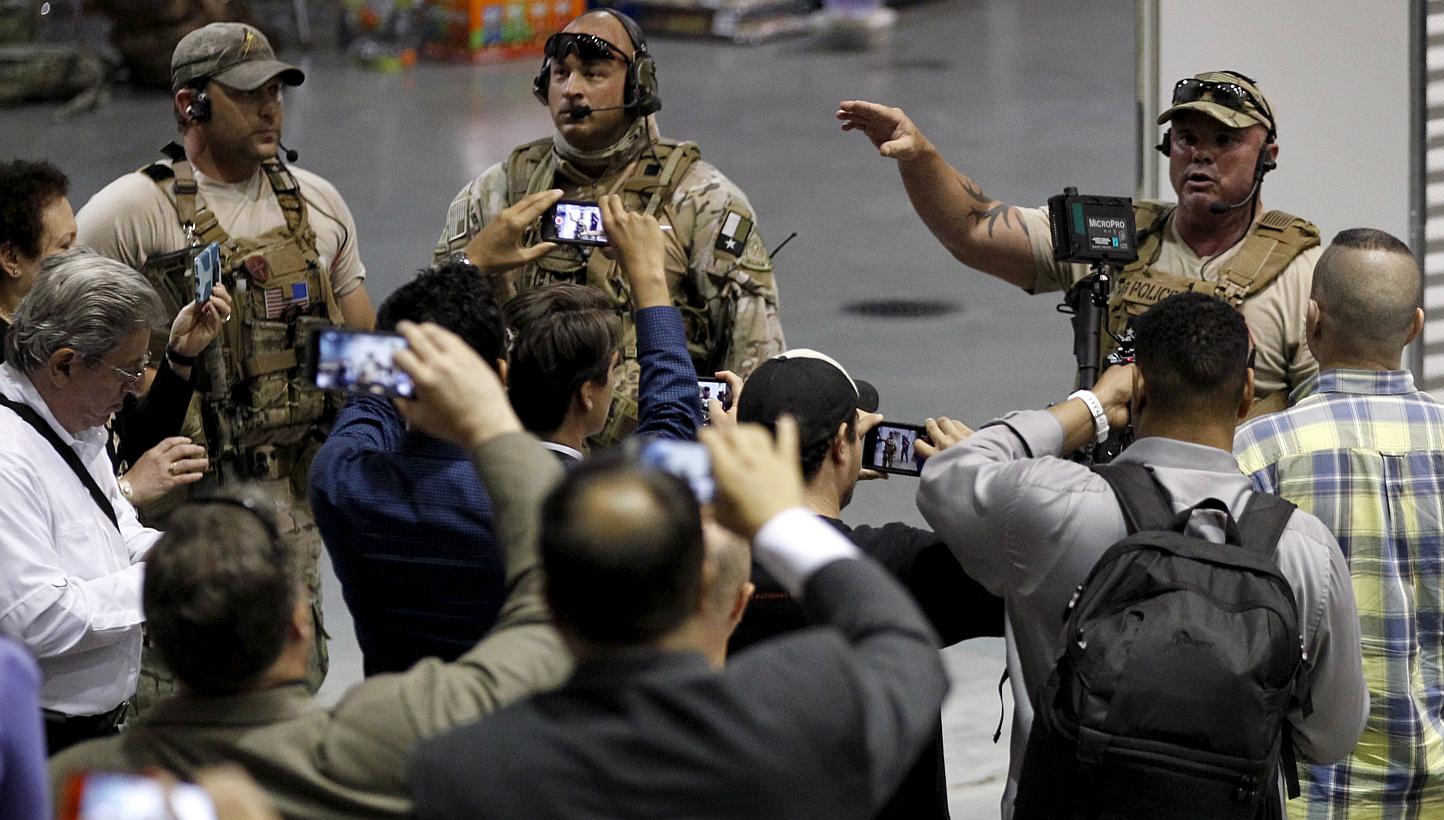 Police officers address attendees at the Muhammad Art Exhibit and Contest. Two gunmen opened fire at an anti-Islam art show featuring depictions of the Prophet Mohammad in Garland, Texas, near Dallas on Sunday. -- PHOTO: REUTERS