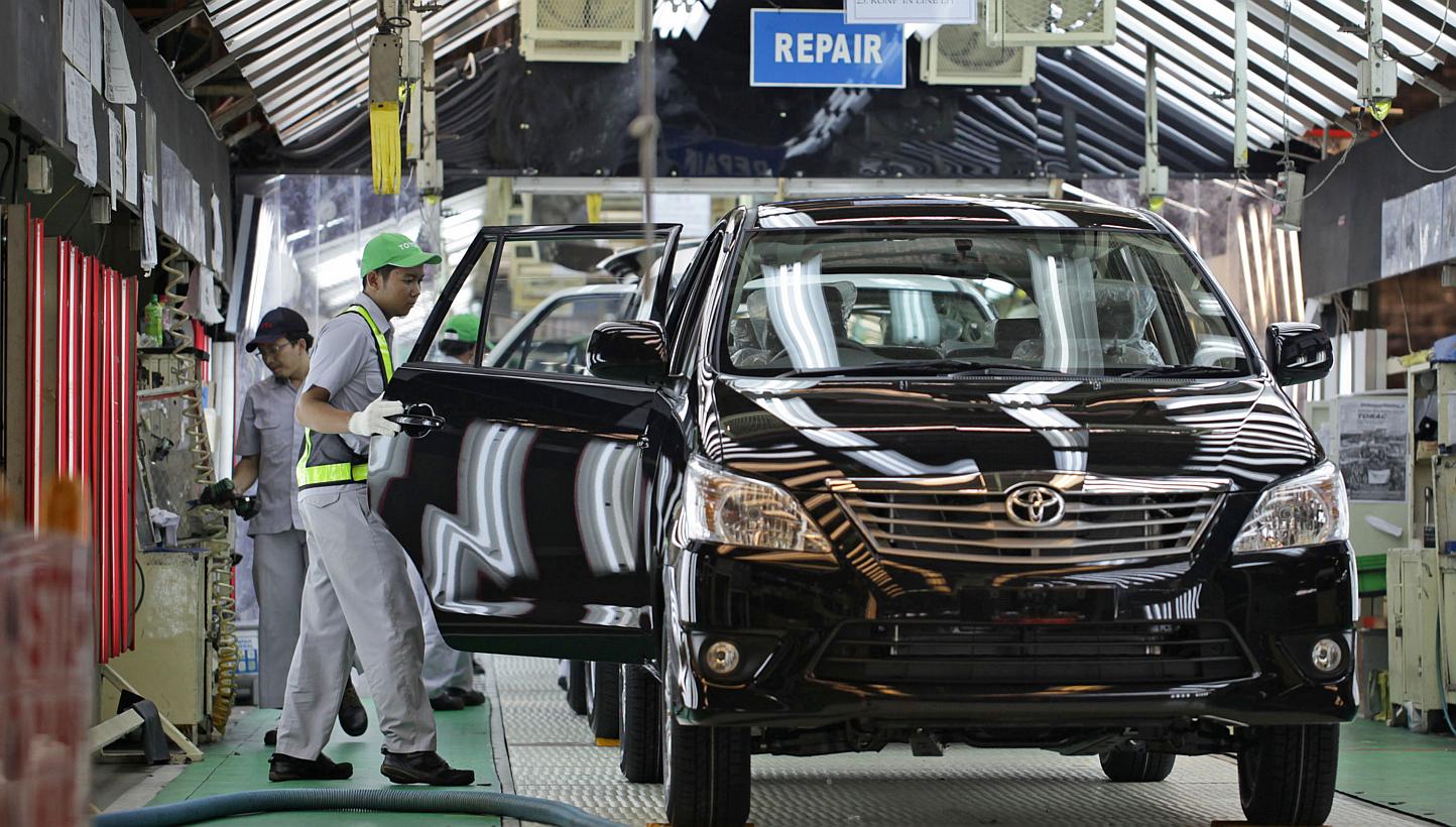 A worker makes a final check on a Toyota Motor Corp. Kijang Innova minivan on the production line of PT. Toyota Motor Manufacturing Indonesia's (TMMIN) Karawang plant in Karawang, West Java, Indonesia. -- PHOTO: BLOOMBERG&nbsp;