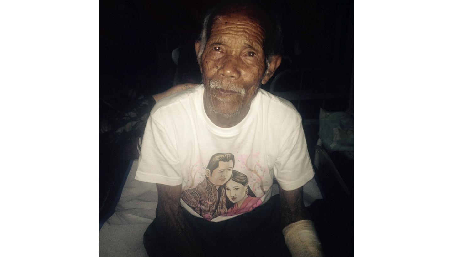 Funchu Tamang, 101, sits on a bed in a hospital in Nuwakot district on May 3, 2015 around 80 kilometres north-west of Kathmandu where he was taken after being rescued from his collapsed home a day earlier. -- PHOTO: AFP&nbsp;