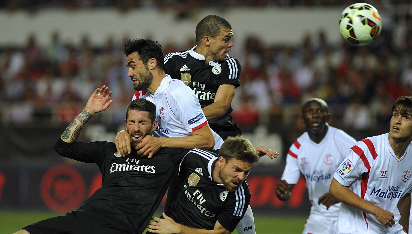 Real Madrid's defender Sergio Ramos (left), Portuguese defender Pepe (top right) and midfielder Asier Illarramendi (second left) vie with Sevilla's midfielder Vicente Iborra (top left) and midfielder Denis Suarez (right) during the Spanish league foo