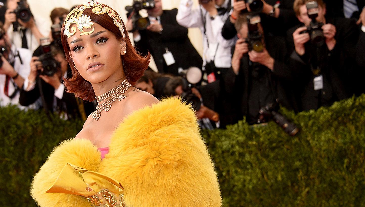 Rihanna wearing a gold tiara and flowing yellow robe at the New York Met Ball on May 4, 2015. The city's party of the year, attended by stars such as Madonna, George Clooney, Sarah Jessica Parker and Robert Pattinson, chose China as the theme of its 