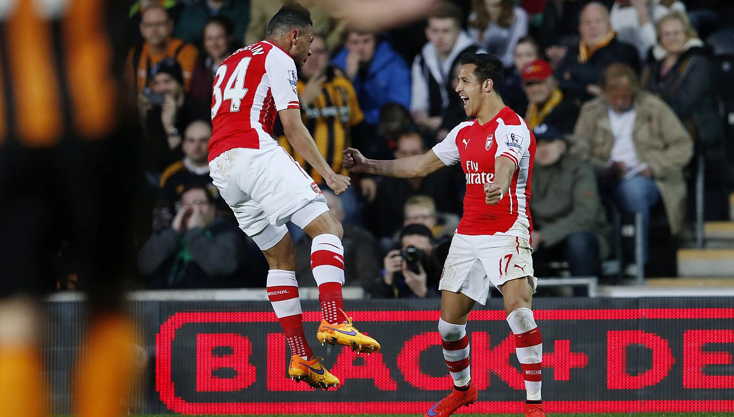 Arsenal forward Alexis Sanchez (right) celebrates with teammate Francis Coquelin after opening the scoring against Hull. -- PHOTO: REUTERS