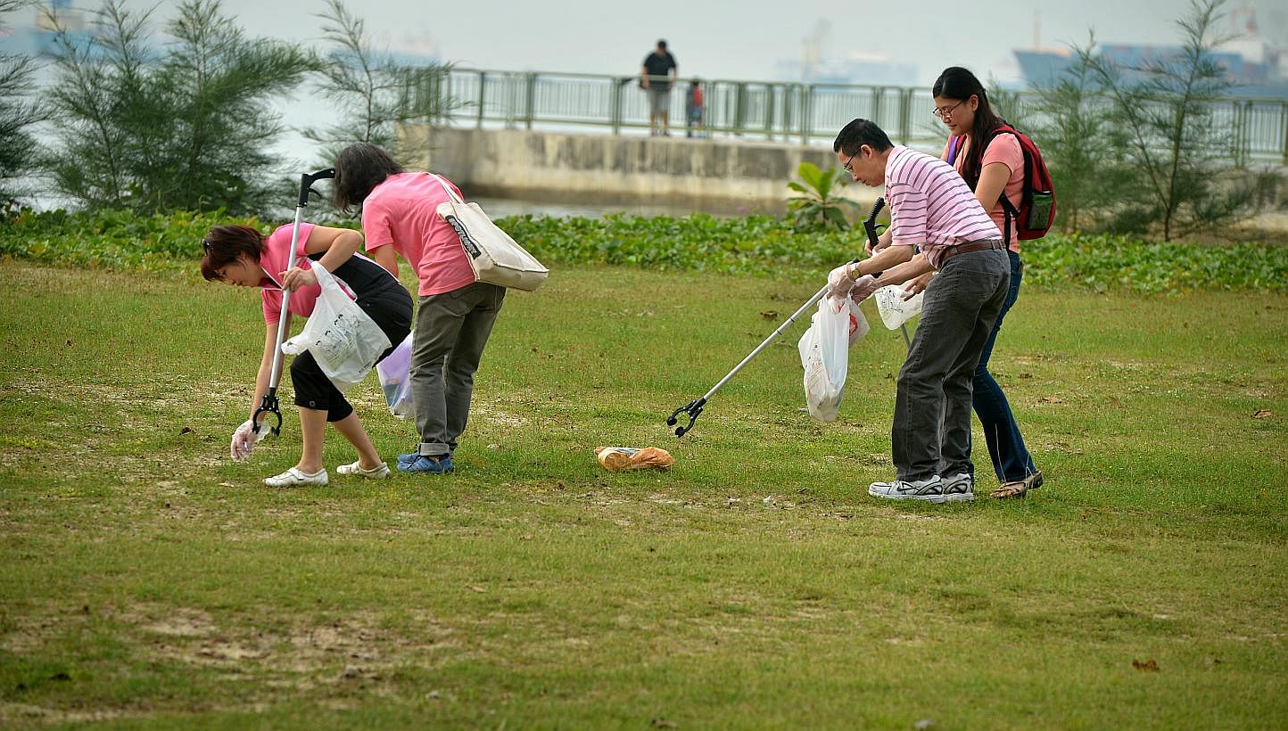 Volunteers picking up litter at East Coast Park. -- PHOTO: ST FILE&nbsp;