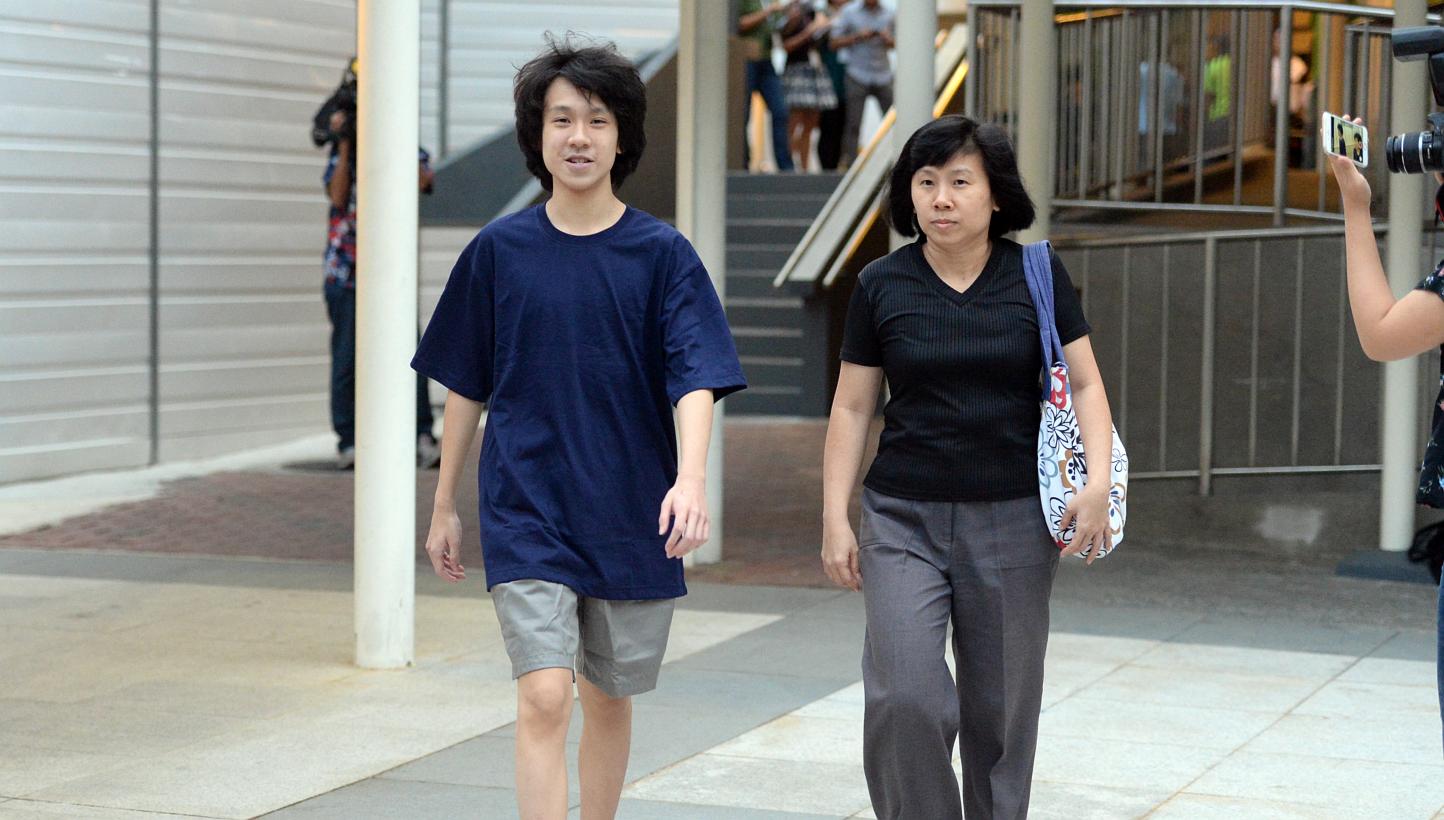 Amos Yee with his mother outside the State Courts on April 21, 2015. A bail review for the teenage blogger will be heard on Wednesday morning at the High Court. -- ST PHOTO: AZIZ HUSSIN&nbsp;