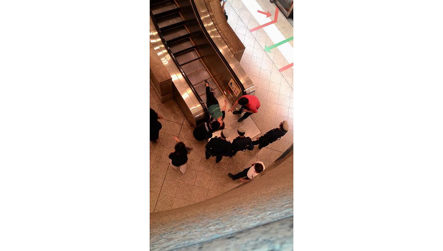 The woman was midway down the escalator when she lost her balance and fell, a witness told Lianhe Wanbao. -- PHOTO: LIANHE WANBAO READER&nbsp;