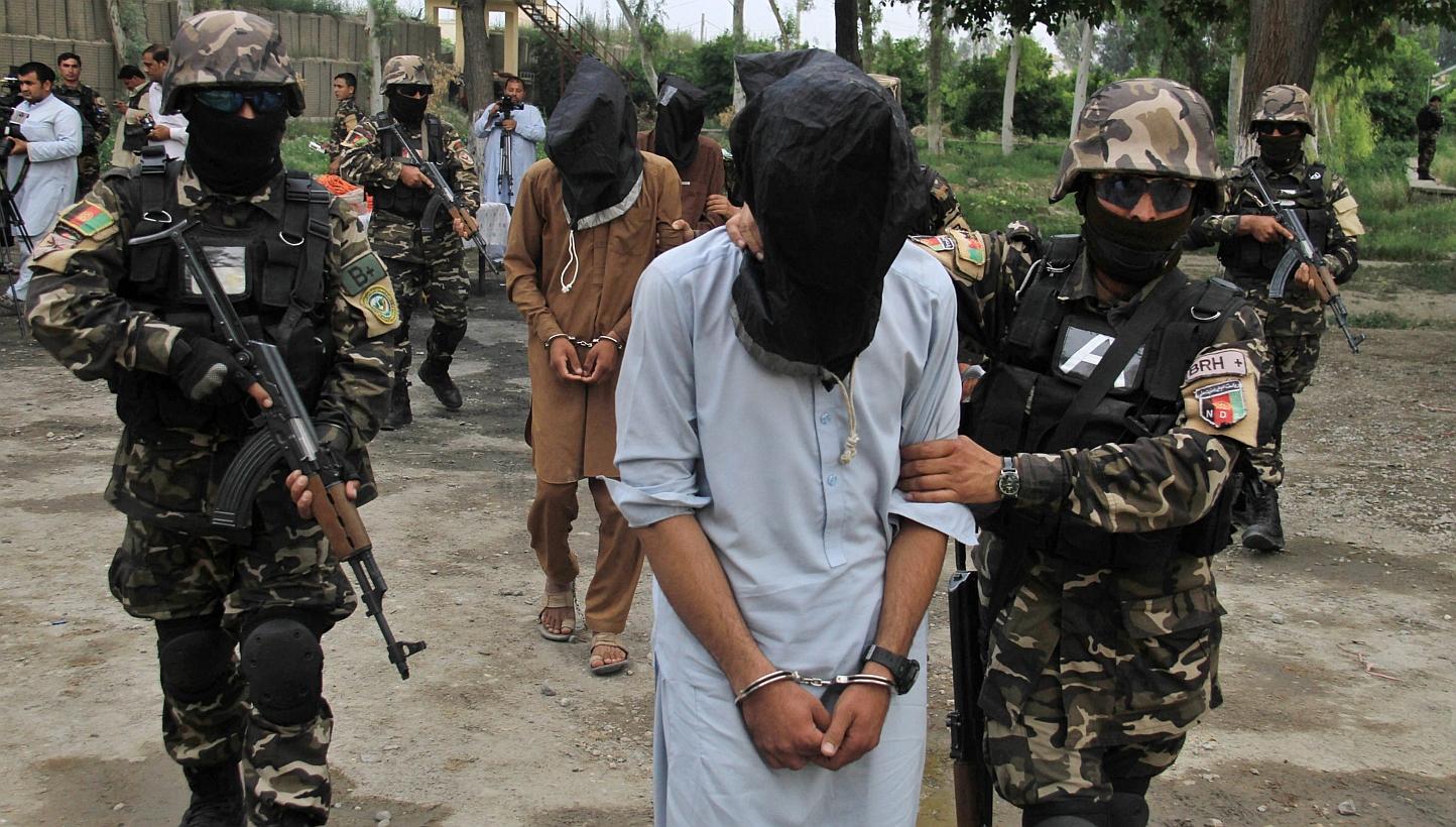Members of the Afghan National Directorate of Security (NDS) escort four suspected Taleban members allegedly involved in criminal activities in the area, after their arrest in Jalalabad, Afghanistan on Monday. -- PHOTO: EPA