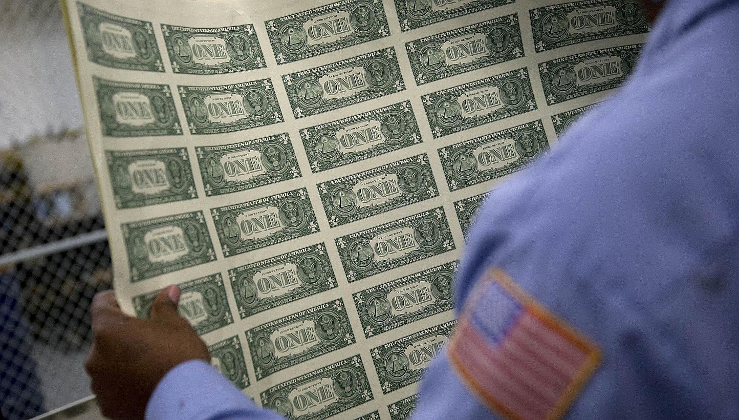 A one dollar note sheet is inspected at the US Bureau of Engraving and Printing in Washington, DC, on April 14, 2015. The Republican-led United States Congress passed a 2016 Budget on Tuesday, a largely symbolic policy document which if fully enacted