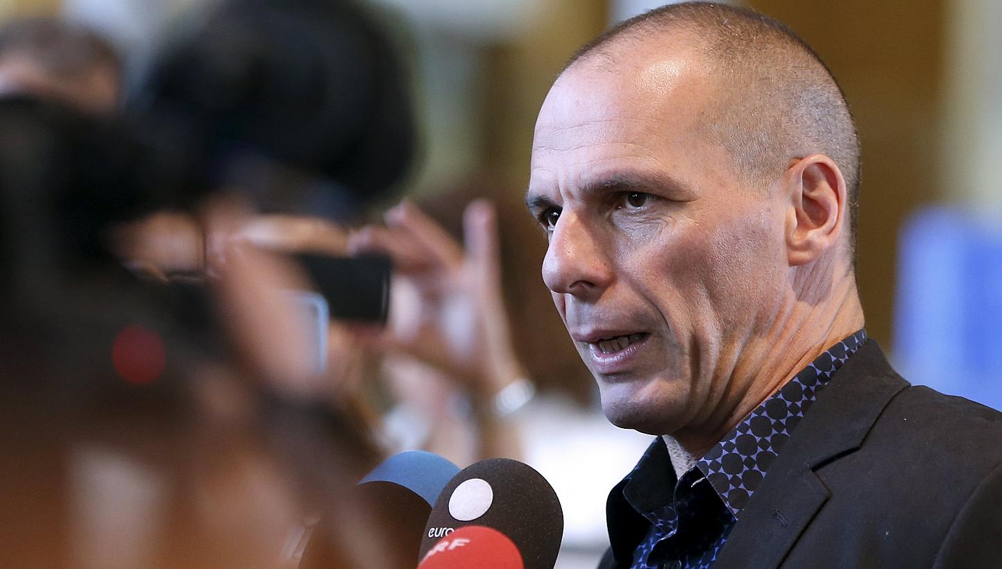 Greek Finance Minister Yanis Varoufakis talking to reporters while leaving the European Commission headquarters in Brussels on May 5, 2015. -- PHOTO: REUTERS