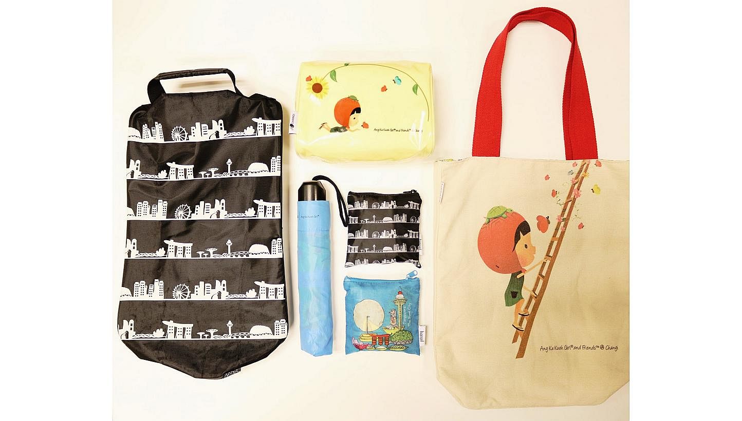 A set of six exclusive premiums designed by local designers Wang Shijia and Jo Soh. The set comprises (clockwise from top) a cosmetics pouch, a canvas tote bag, foldable shopping bags, a foldable umbrella and a shoe bag. -- PHOTO: CHANGI AIRPORT GROU