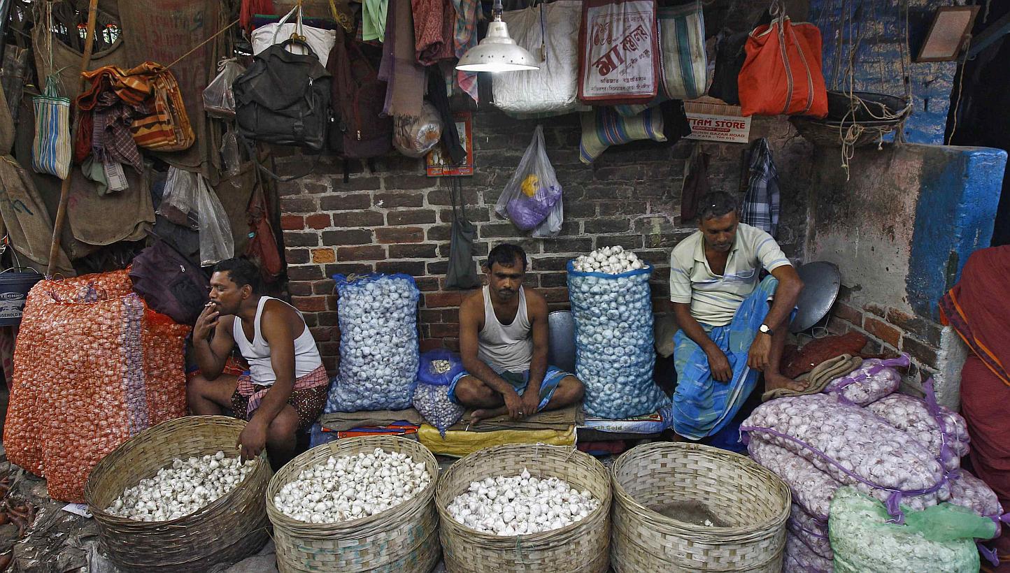 Garlic vendors waiting for customers at their stall at a wholesale vegetable market in Kolkata on Feb 27, 2015. India's lower house of parliament passed a bill on Wednesday, May 6, that seeks to transform the country into a common market with a singl