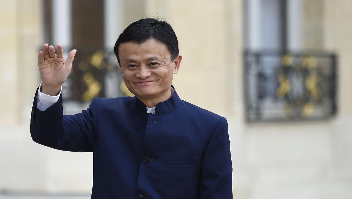 Alibaba founder Jack Ma waving to journalists as he arrives for a meeting with French President Francois Hollande at the Elysee Palace in Paris on March 18, 2015. After Alibaba raised a record US$25 billion (S$33 billion) last year, Mr Ma said the Ch