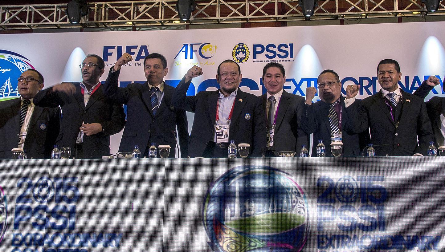 This photo taken on April 18, 2015 shows newly-elected Indonesian Football Association (PSSI) chief La Nyalla Mattalitti (fourth left) standing with new officials of the PSSI following his election in Surabaya, East Java province. FIFA has ordered th
