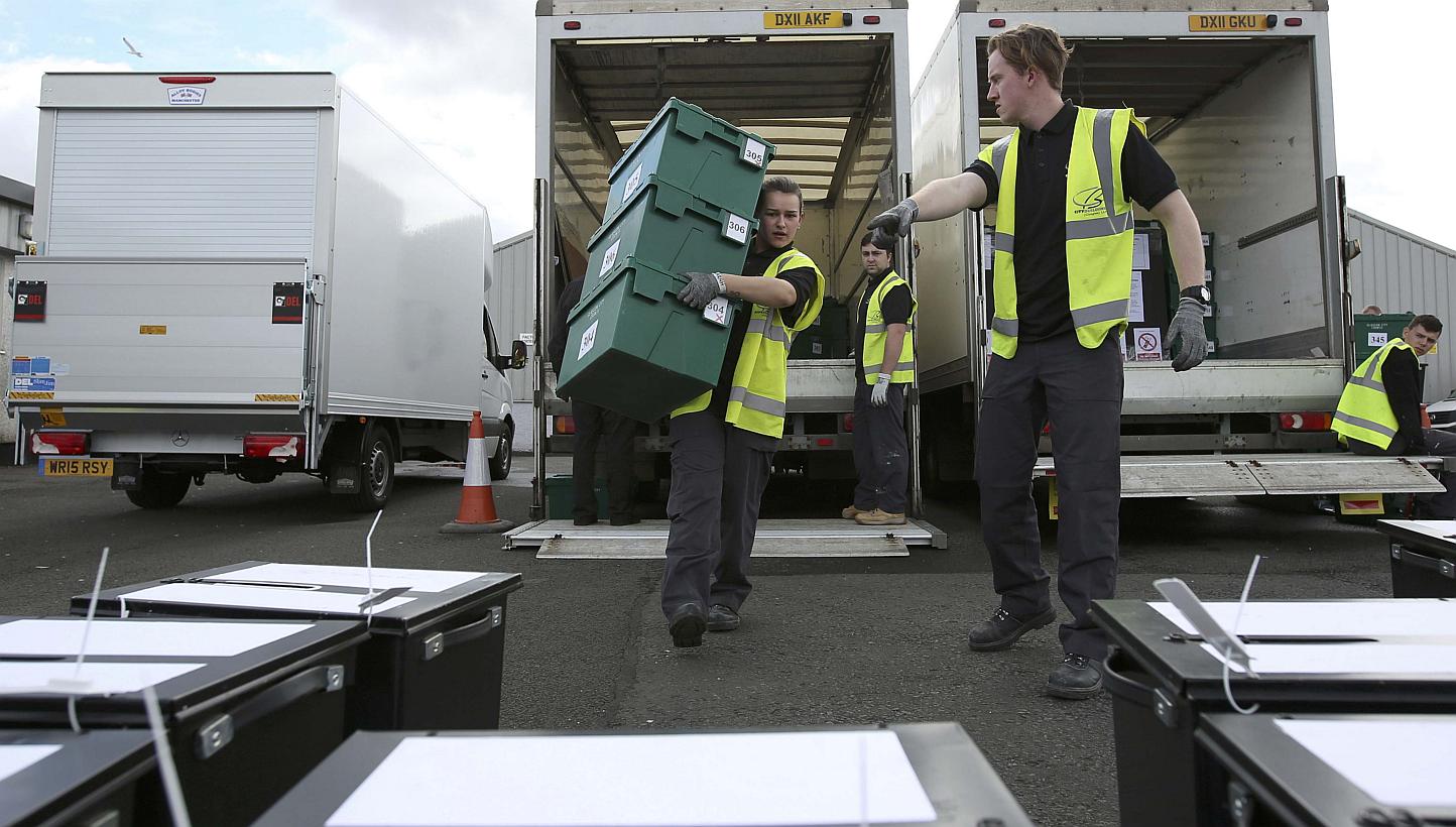 City council workers assemble ballot boxes for distribution ahead of the next day's general election, in Glasgow, Scotland on May 6, 2015. British Prime Minister David Cameron's Conservative Party is one point ahead of the opposition Labour Part