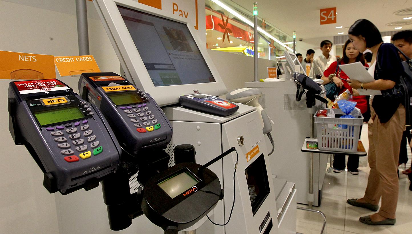 Some new high-tech payment methods such as contactless cards are getting the cold shoulder from Singapore shoppers, who prefer to stick with cash, according to a new study yesterday. -- PHOTO: ST FILE