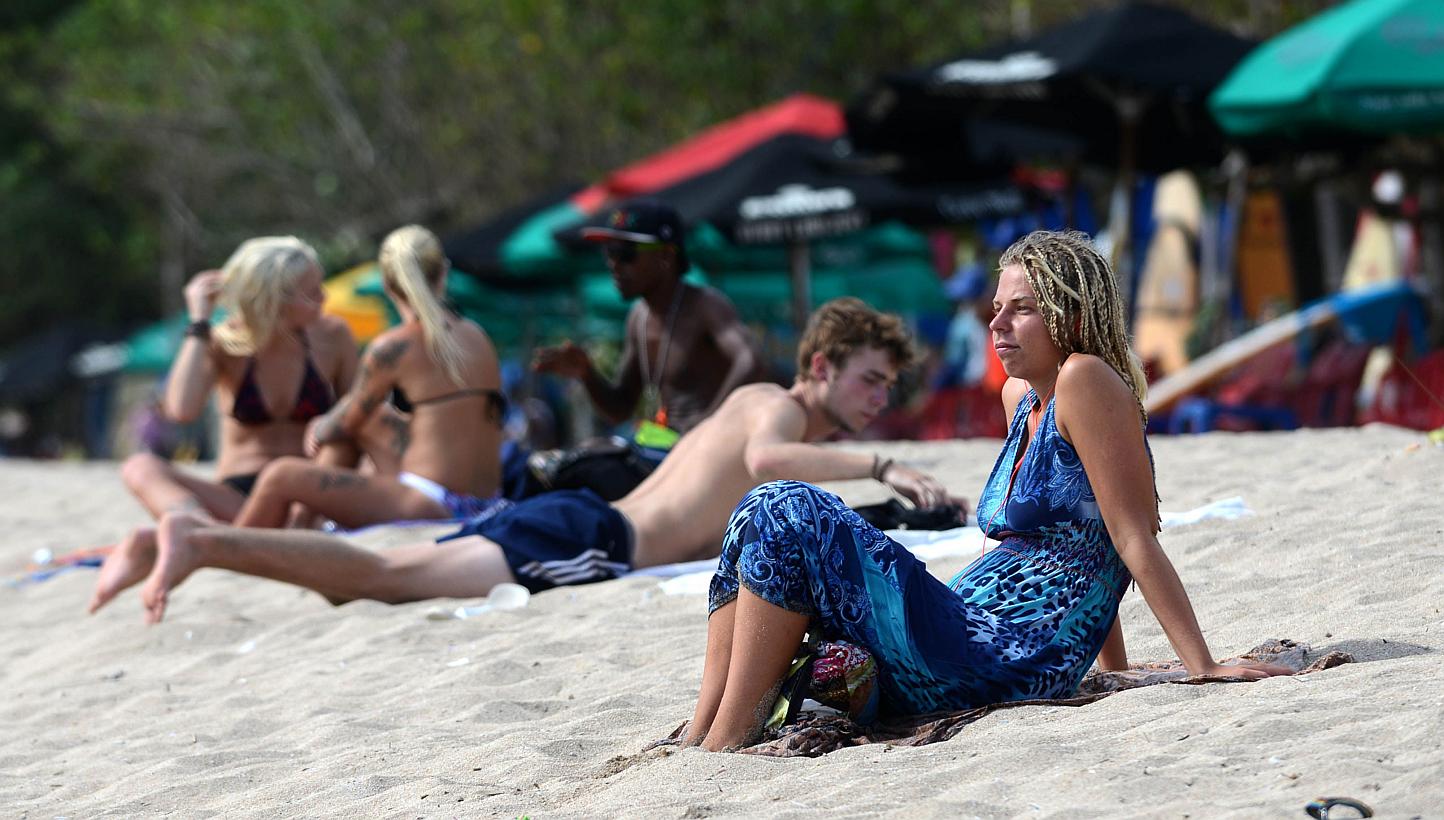 Foreign tourists sunbathing on Kuta beach, Bali island on March 17, 2015.&nbsp;The number of Australian visitors to Indonesia rose in March and the island nation's tourism industry has seen no impact from a Boycott Bali protest over death sentences p