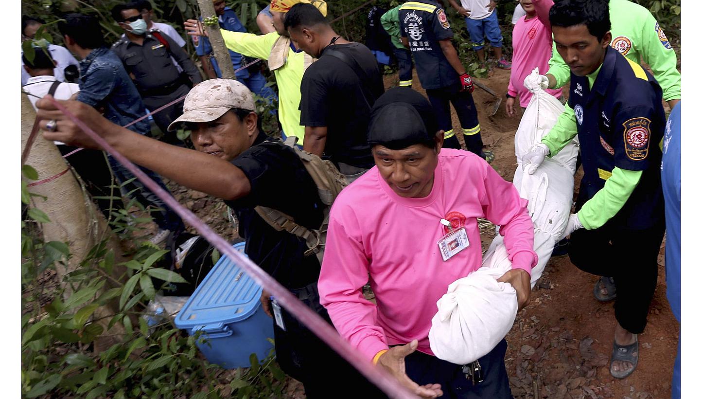 Thai rescue workers collect the recovered remains of a suspected Rohingya migrant after discovering another grave site at a long-abandoned Muslim cemetery in Sadao district, Songkhla province near the Thai-Malaysian border in southern Thailand on May