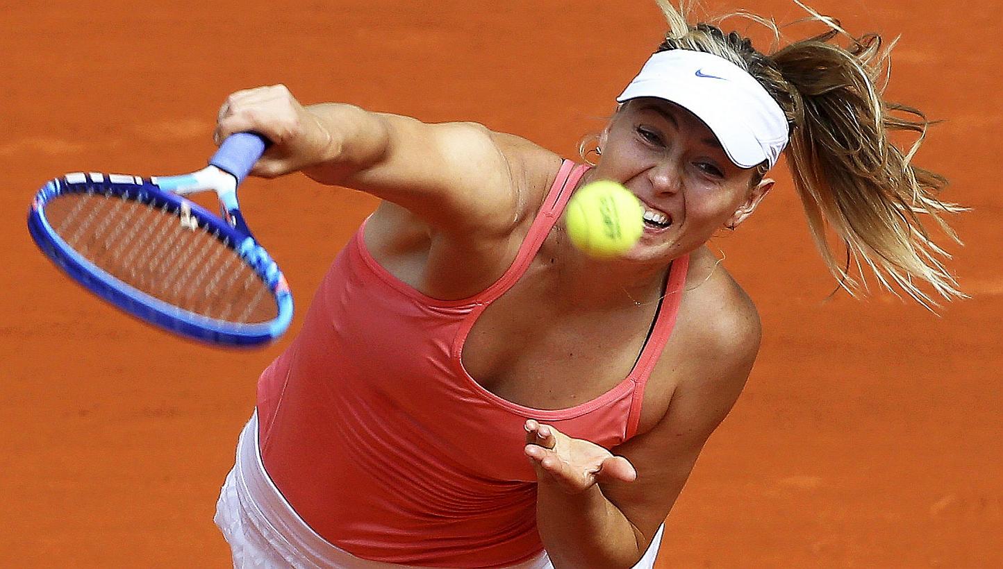 Russia's Maria Sharapova serves the ball to Denmark's Caroline Wozniacki during their quarter final match of the Mutua Madrid Open tennis tournament on May 7, 2015. -- PHOTO: EPA