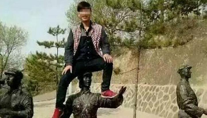 A man was placed on China's tourist blacklist for 10 years for climbing on top of a Red Army statue for a photo at a tourist attraction. -- PHOTO: SINA WEIBO