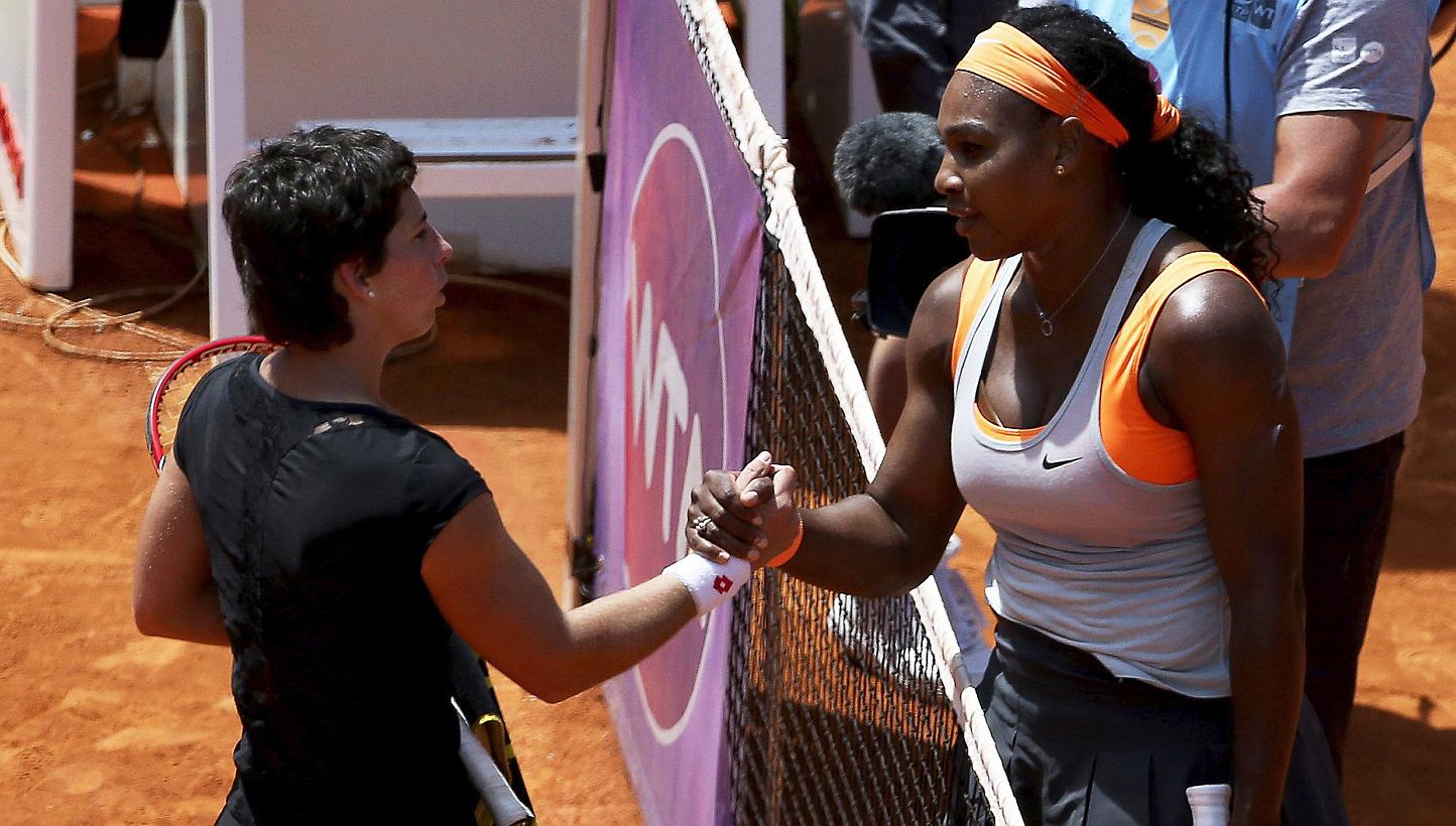 Serena Williams (right) of the USA is congratulated by Spain's Carla Suarez Navarro (left) after winning their quarter final match of the Mutua Madrid Open tennis tournament on May 7, 2015. -- PHOTO: EPA