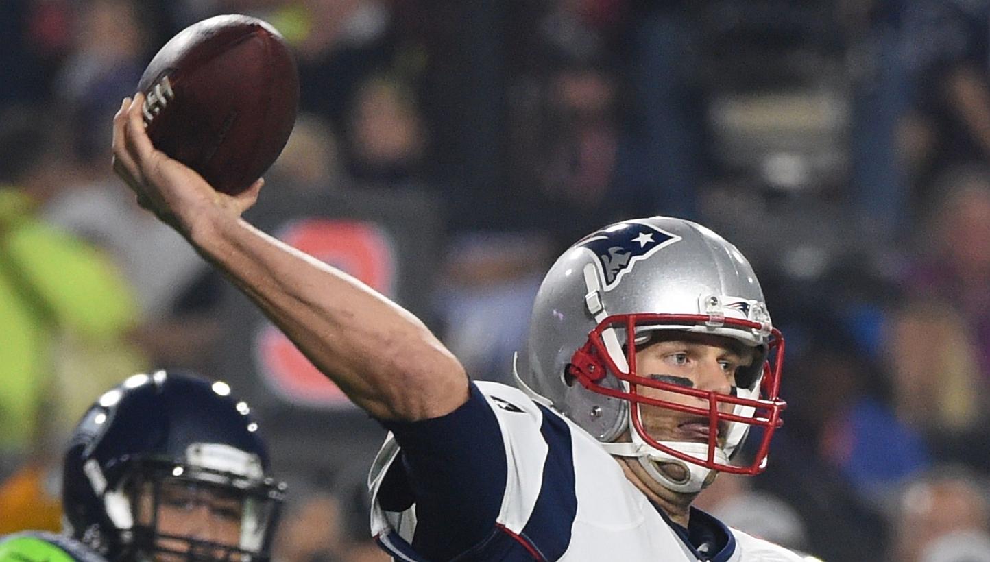 Quarterback Tom Brady (centre) of the New England Patriots prepares to pass against the Seattle Seahawks during Super Bowl XLIX in this February 1, 2015, file photo, at the at University of Phoenix Stadium in Glendale, Arizona. -- PHOTO: AFP