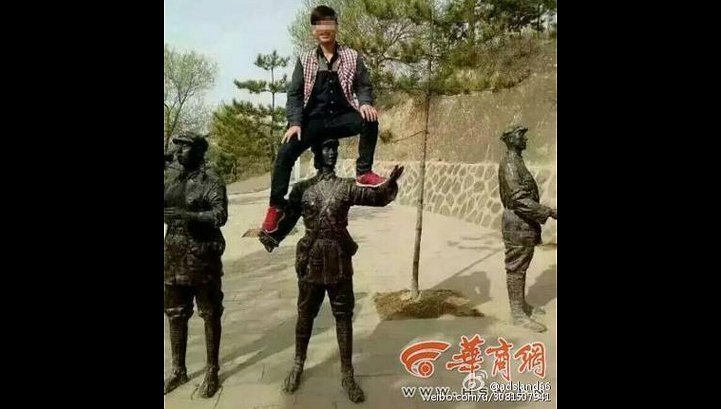 Li Wenchun has been punished for climbing onto a statue depicting a soldier of the Red Army at a commemorative park in China last month.