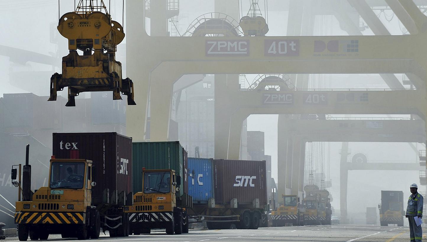 Shipping containers are loaded onto trucks at Dayaowan port in Dalian, Liaoning province, in 2012. China's exports shrank in April, adding downward pressure on an economy grappling with overcapacity and a property slump. -- PHOTO: REUTERS