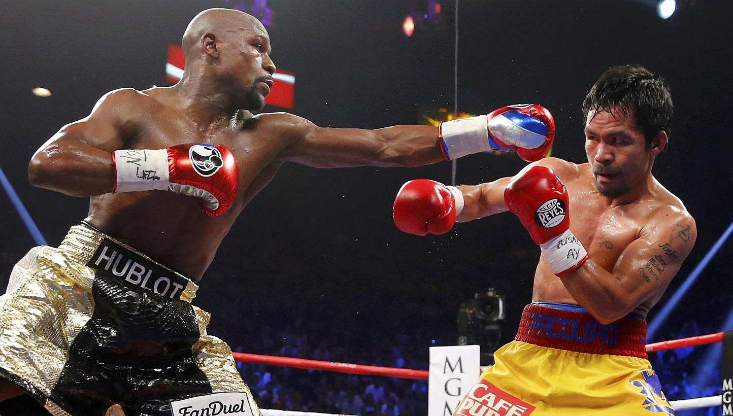 Floyd Mayweather Jr (left) and Manny Pacquiao during the fifth round of their fight in Las Vegas on May 2, 2015. Two days after saying he would be open to a re-match with Pacquiao, Mayweather reversed course on Thursday, describing the Filipino as "a