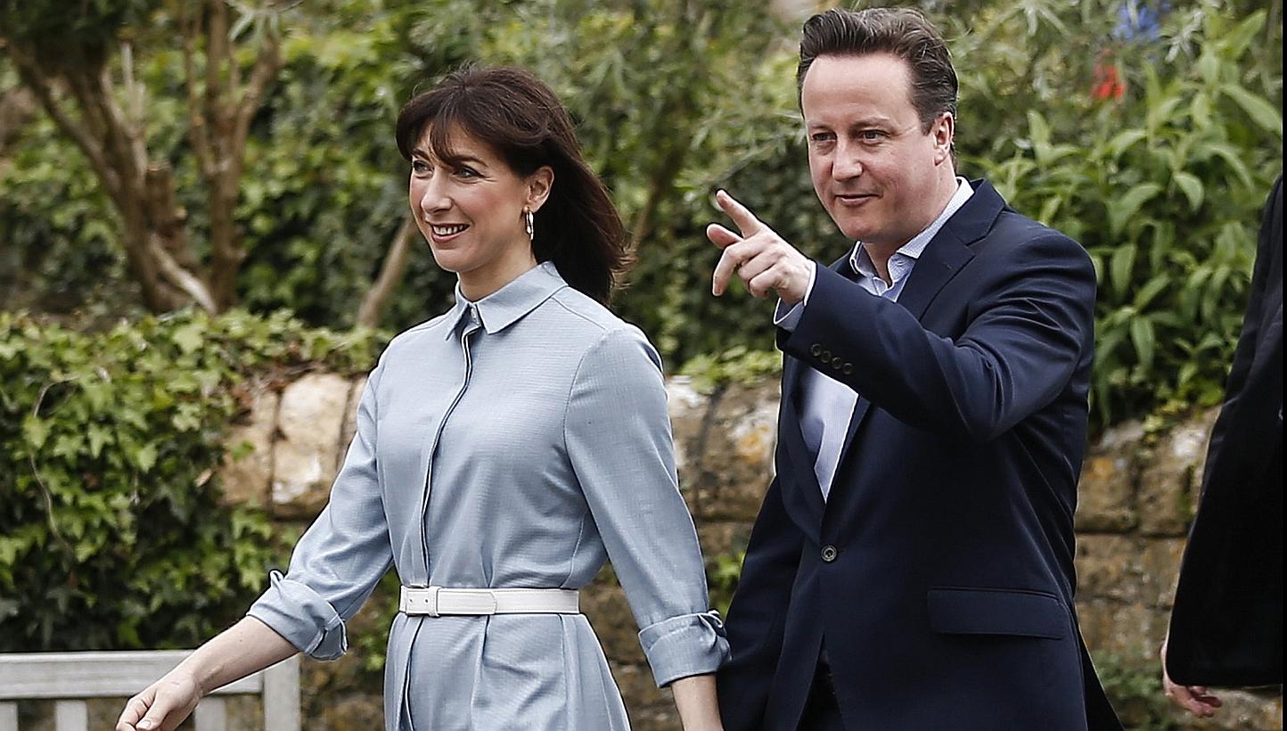 Mr David Cameron, British prime minister and leader of the Conservative Party, center right, and Mrs Samantha Cameron, his wife, leave after casting their votes in the general election at a polling station in Spelsbury on Thursday. Cameron's&nbsp;Con