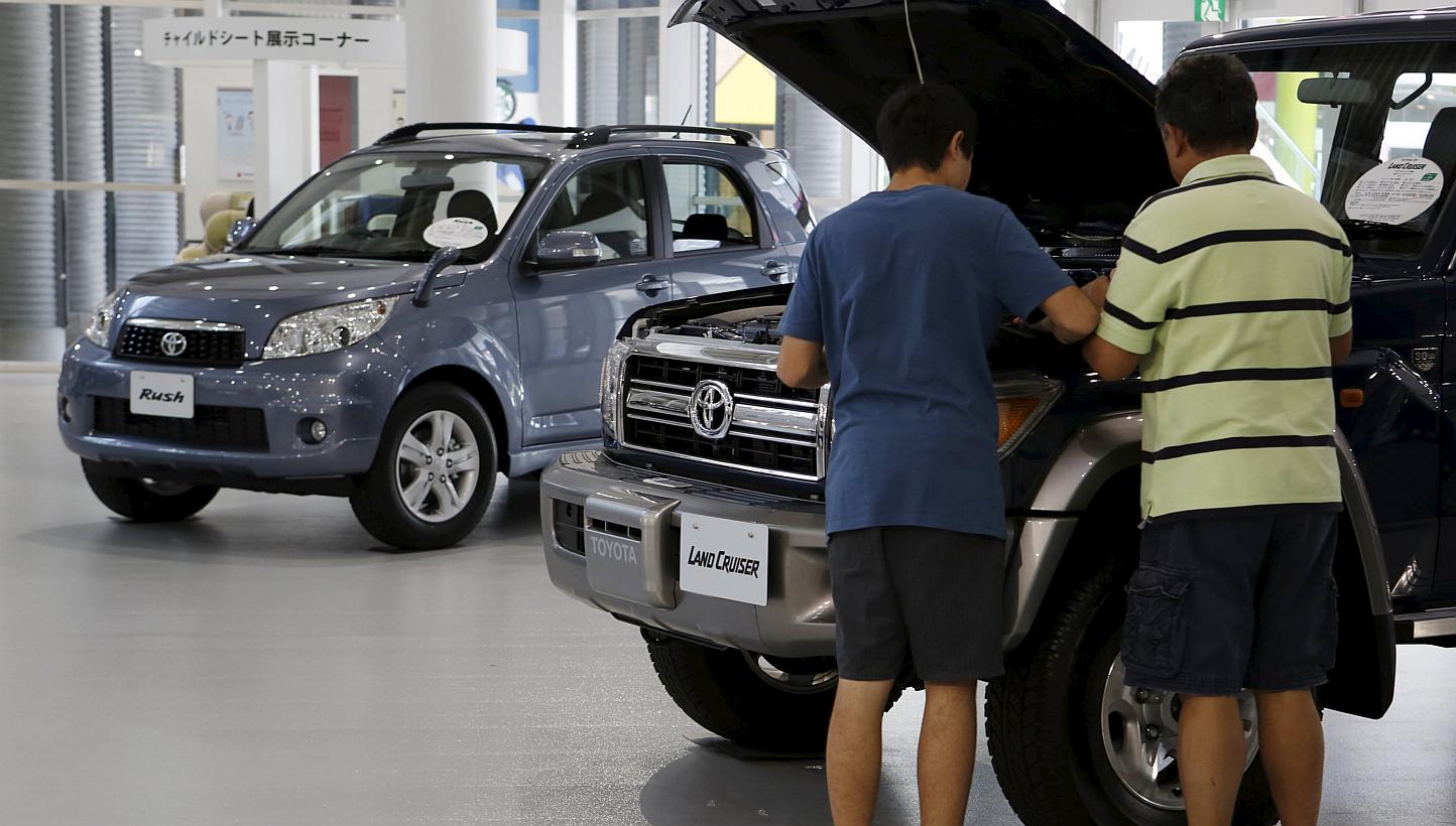 Visitors looking at a Toyota Motor's vehicle, displayed at the company's showroom in Tokyo, Japan on May 8, 2015. -- PHOTO: REUTERS