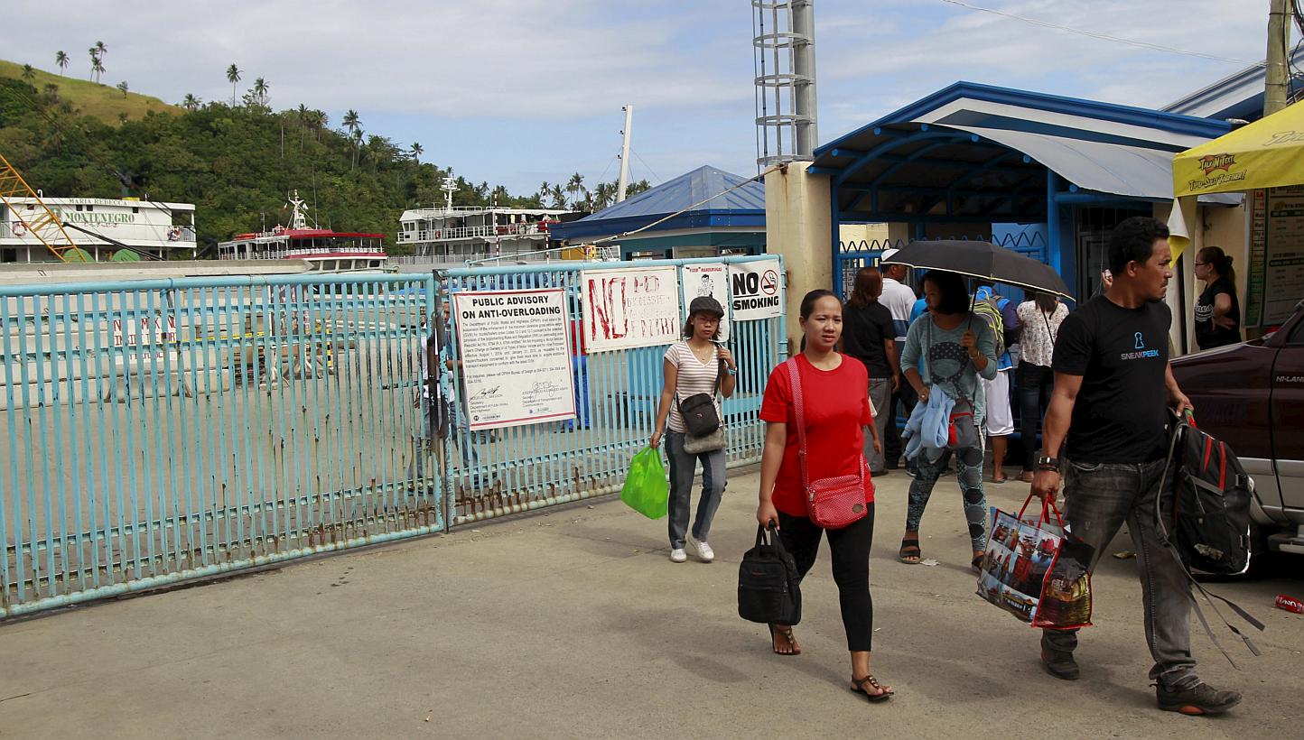 Stranded passengers leaving a port after learning that ferry services were stopped in preparation for an approaching storm in Marinduque island, central Philippines, on April 4, 2015. -- PHOTO: REUTERS 