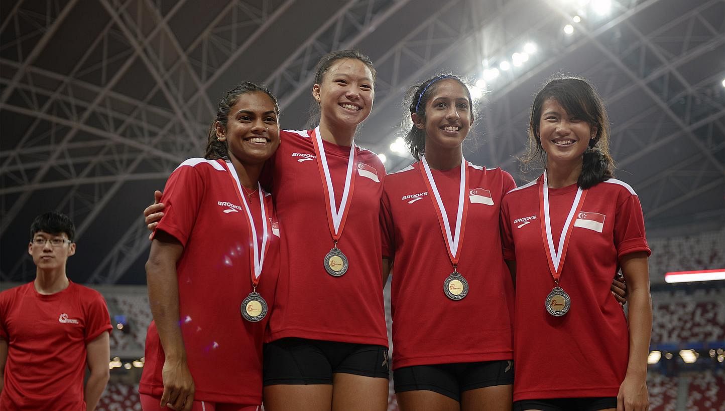 Eugenia Tan (second left), who only just switch over to long jump, at the 77th Singapore Open Track &amp; Field Championships with the 4x100m Singaporean womens' team on April 4, 2015. -- PHOTO: ST FILE &nbsp;