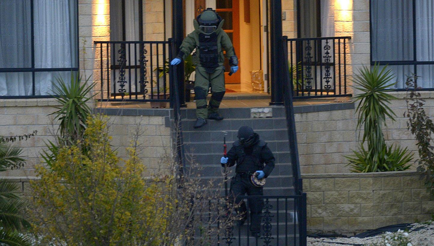 Officers wearing bomb suits raid a home in Greenvale, Melbourne, Australia on May 8, 2015. Australian police said on Sunday, May 10, that a teenager charged with a terrorist bomb plot was "well advanced" in plans to target a public event, adding