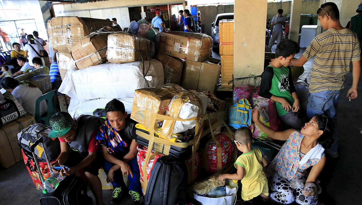 Stranded passengers guard their belongings while waiting at a bus terminal in Manila on May 9, 2015. -- PHOTO: REUTERS 