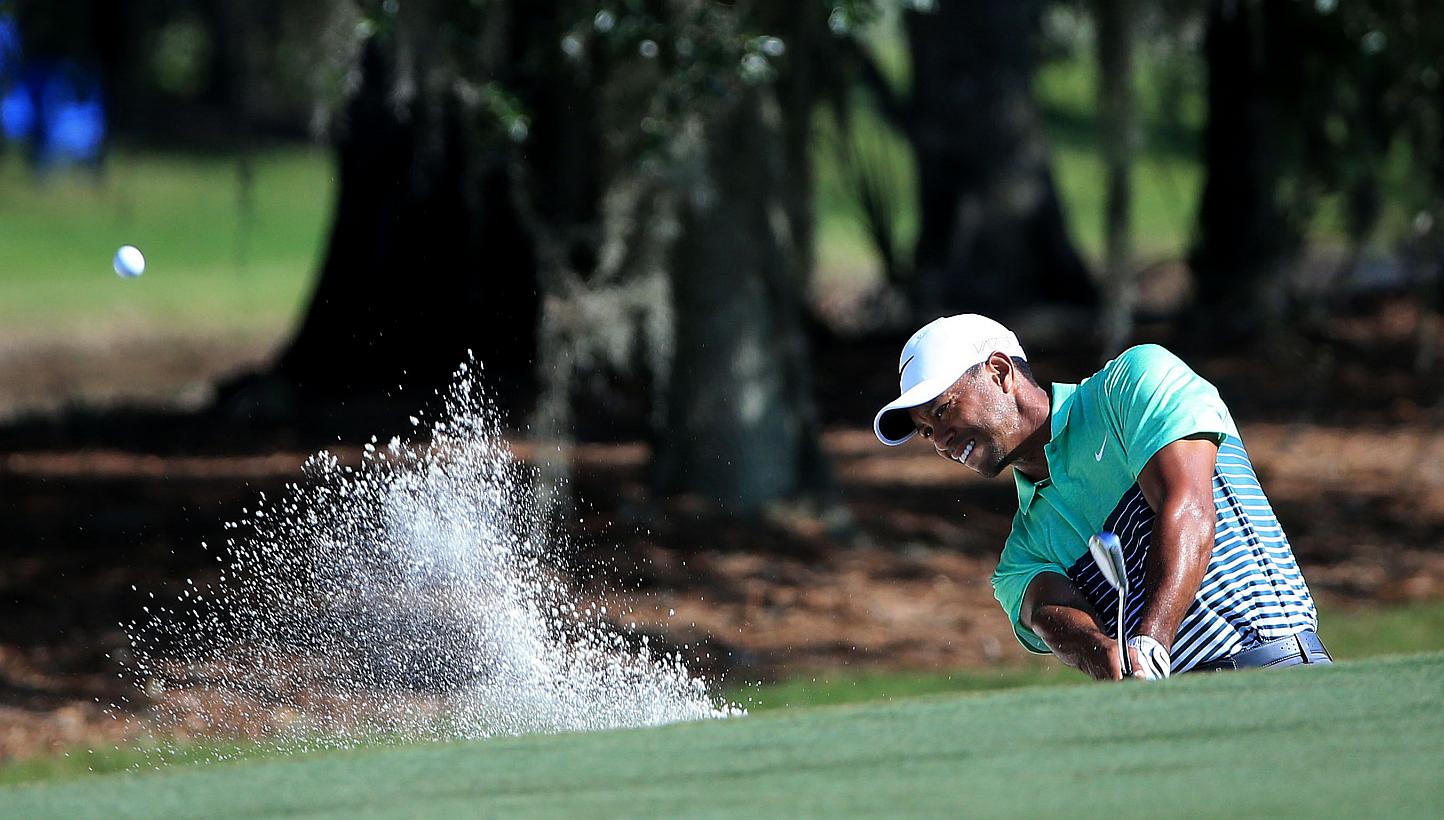 Tiger Woods plays a shot from a bunker on the second hole during round three of the Players Championship at the TPC Sawgrass Stadium course on May 9, 2015. -- PHOTO: AFP&nbsp;