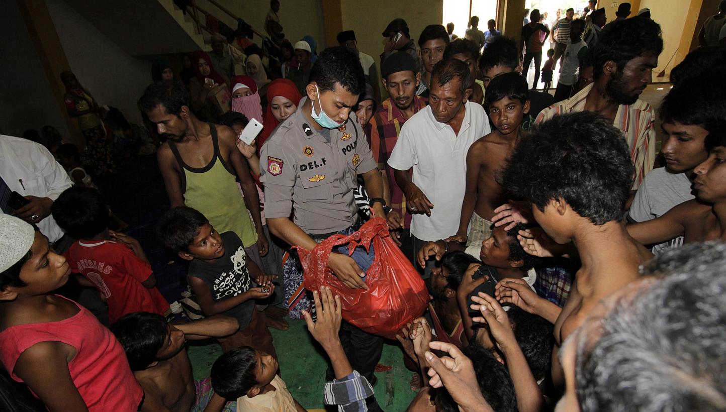 Rohingya refugees line up for breakfast in the sport stadium of Lhok Sukon, North Aceh, Sumatra, Indonesia on May 11,&nbsp;2015. Bangladeshi police arrested three human traffickers on Monday after killing four in recent days and arresting more than 1