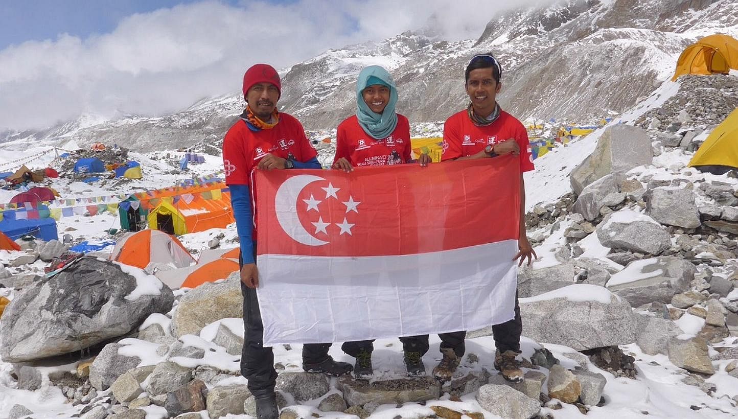 The three members from Aluminaid Team Singapore Everest 2015 are (from left) Mr Zulkifli Latiff, Ms Nur Yusrina Ya’akob and Mr Ismail Latiff, holding the Singapore flag at the Everest base Camp. Due to safety reasons, their expedition was called of
