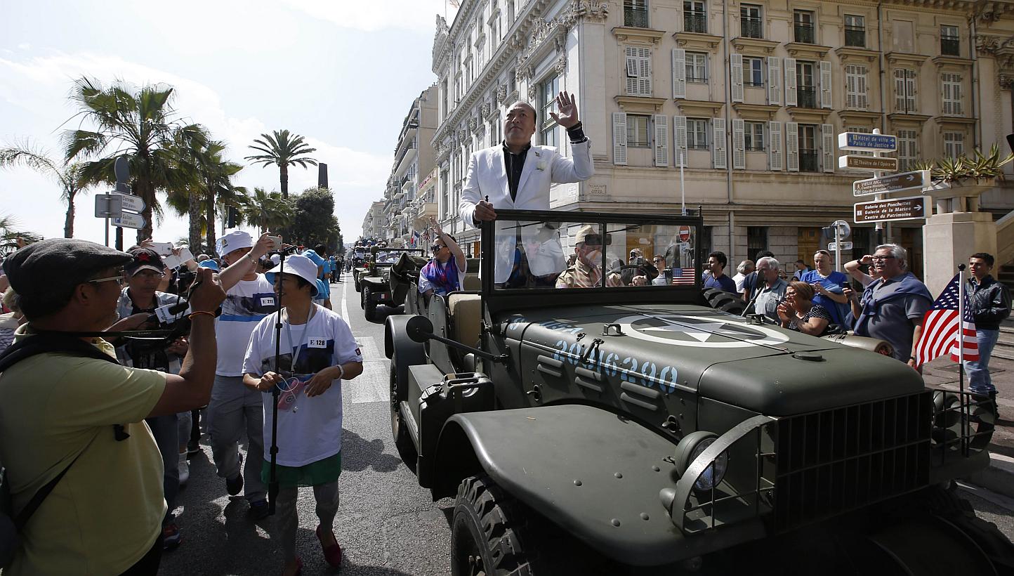 Li Jinyuan, chairman of Chinese company Tiens Group, parading in the French Riviera city of Nice. The company invited 6,400 of its employees to celebrate its 20th anniversary in France. -- PHOTO: AFP