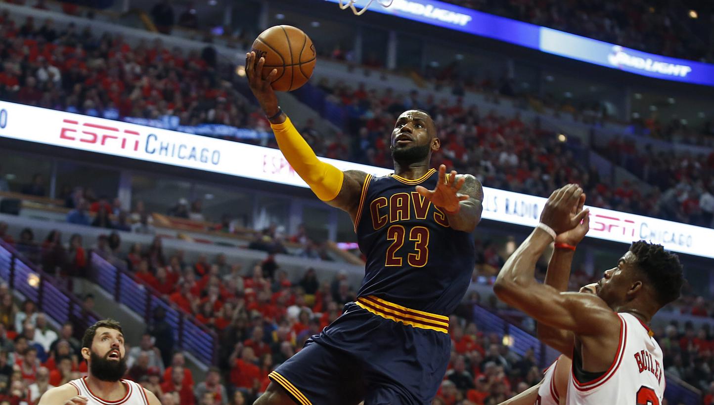 Cleveland Cavaliers forward LeBron James (centre) goes to the basket against Chicago Bulls forward Nikola Mirotic (left) and guard Jimmy Butler (right) during the first half of game four of the NBA Eastern Conference semifinals between the Cleveland 